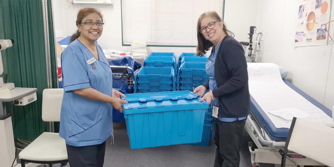 Registered nurses Sheela Marjoshi and Joy Fabic take one of the crates to the big job of packing up the Eye Clinic.